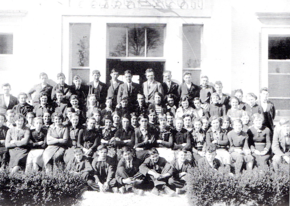 0009 : This is one of the earlier photos of the school. Notice the gravel footpath and the shrubs in front of the building. Centre of the back row; Mr. Higgins, Mr. O’ Connell and Mr. Twomey.