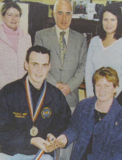 0172 : Gaelcholáiste Uí Chonbás Darragh O'Shea with the world championship medals he won in Daejeon City in South Korea at the Tae Kwon Do World Championships. He won one silver and two bronze medals, and is pictured with múinteoirí Siobhán Ní Chonchúir, Lucy Corbett, S. Ní hAirchnéide and Principal Pádraig Flanagan.